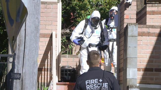 Officers in full-body hazmat suits at the scene of a raid on an Arncliffe apartment where nuclear material was allegedly discovered. Picture: ONSCENE..