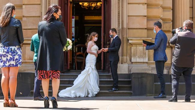 A wedding is held outside the Melbourne registry office on Monday. Picture: Asanka Ratnayake/Getty Images