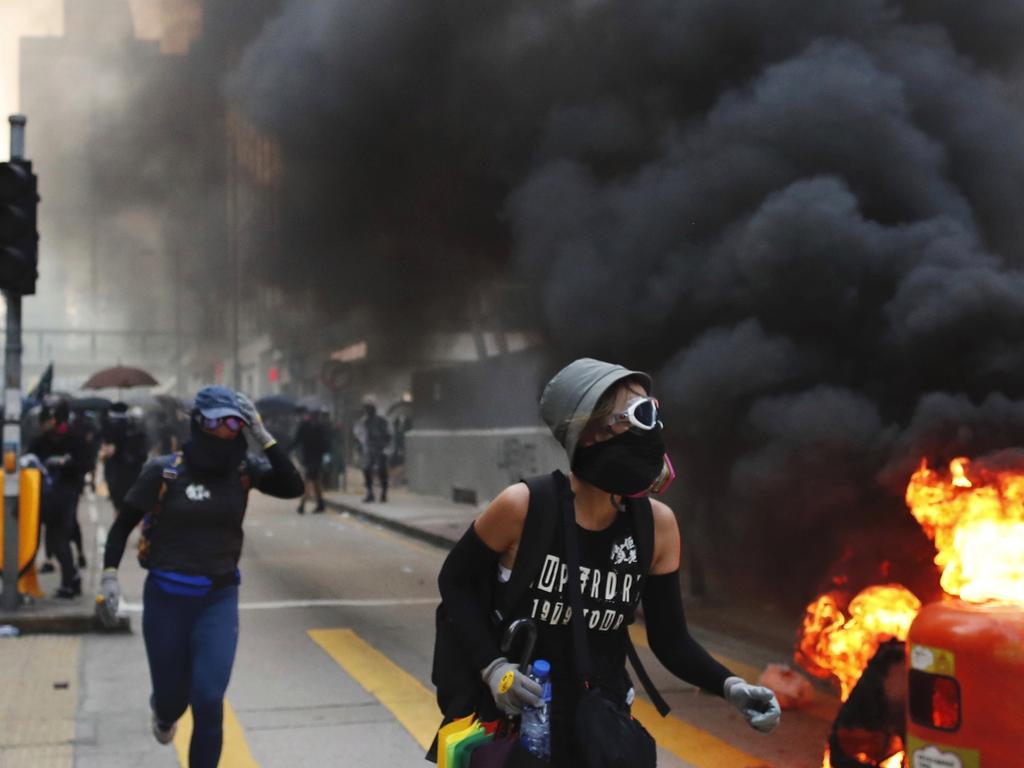 Protesters take cover in Hong Kong. Picture: AP