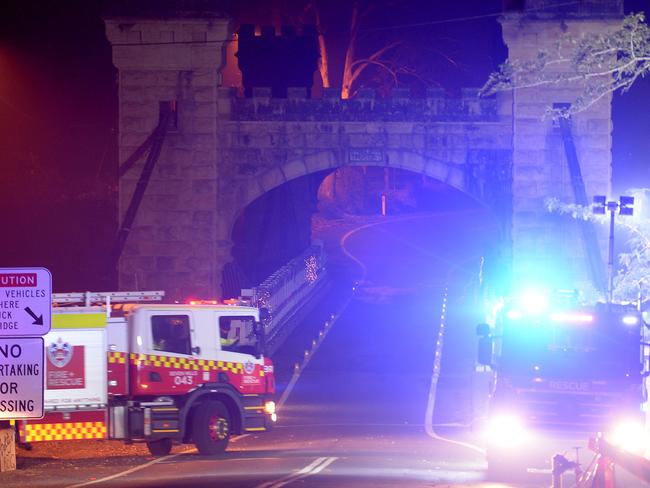 Fire fighters on dousing historic Hampden Bridge in Kangaroo Valley in water as fire approaches. Picture: Jeremy Piper