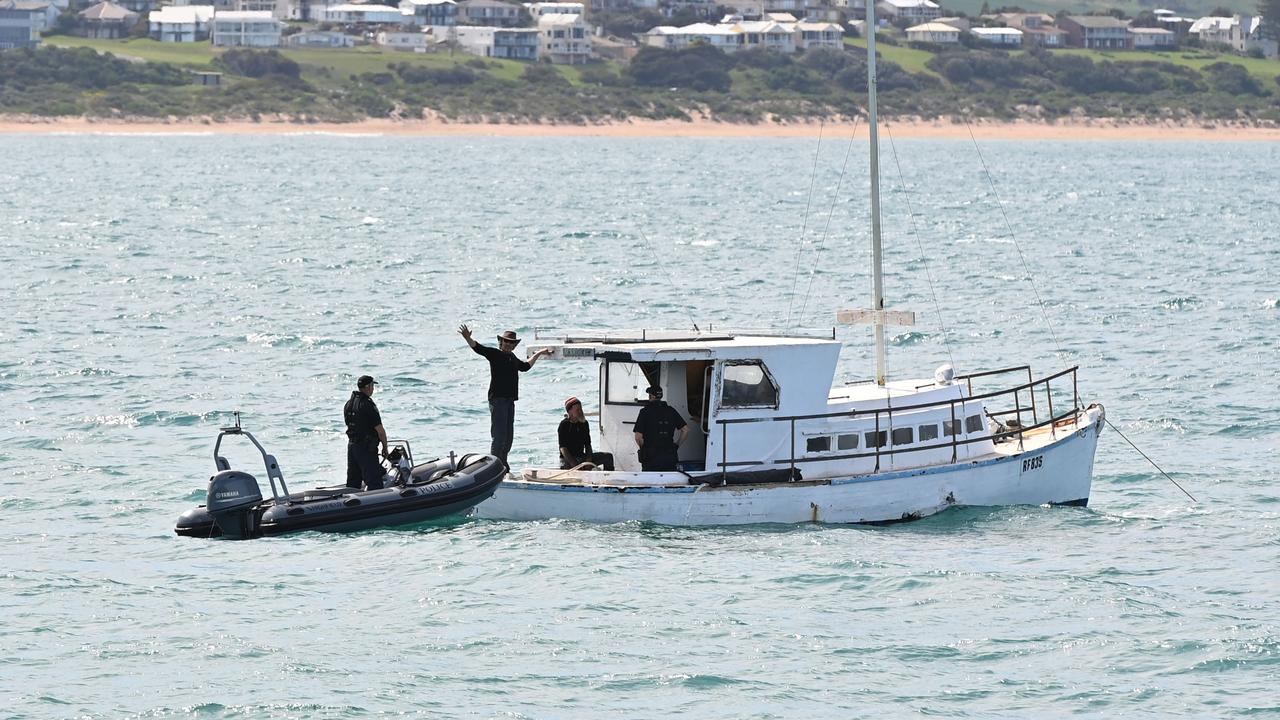 A police dinghy next to Tony Higgins and Derek Robinson’s boat Margrel. Picture: Keryn Stevens