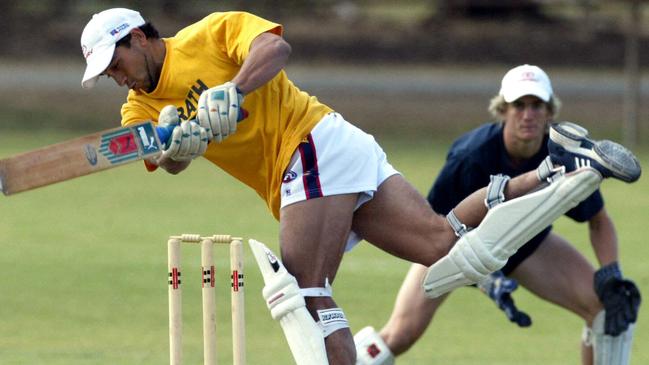 Former Crows star Andrew McLeod batting during a club training camp at Strathalbyn Oval in 2004.