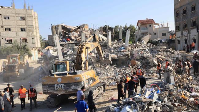 Diggers are used to remove the rubbles of a building destroyed by Israeli bombardment as rescuers look for victims and survivors in Rafah in the southern Gaza Strip. Picture: AFP