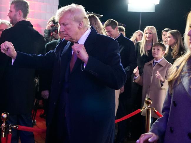 US President-elect Donald Trump, with his wife Melania Trump (R), dances after watching fireworks during a reception in his honor at Trump National Golf Club Washington DC in Sterling, Virginia, on January 18, 2025. (Photo by Alex Brandon / POOL / AFP)