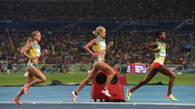 Australia's Genevieve Lacaze (left) and Eloise Wellings (centre) run during the final of the Women's 5000m at Olympic Stadium, 2016. (AAP Image/Dave Hunt)