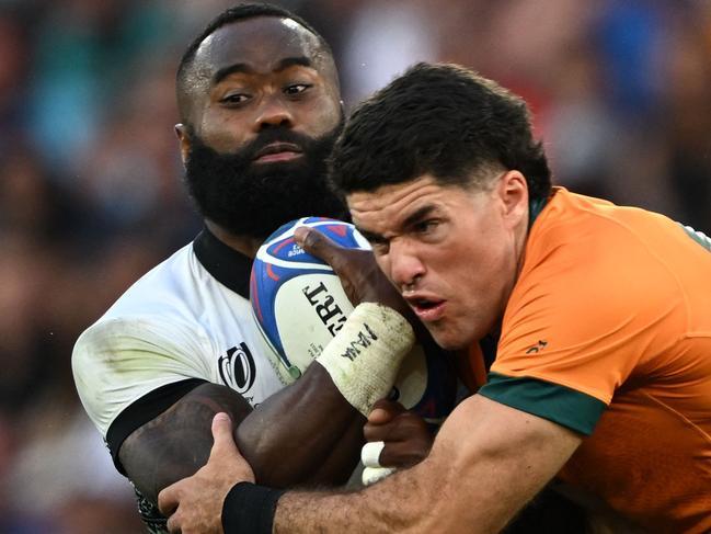 Fiji's left wing Semi Radradra (L) is tackled by Australia's full-back Ben Donaldson (R) during the France 2023 Rugby World Cup Pool C match between Australia and Fiji at Stade Geoffroy-Guichard in Saint-Etienne, south-eastern France on September 17, 2023. (Photo by Olivier CHASSIGNOLE / AFP)