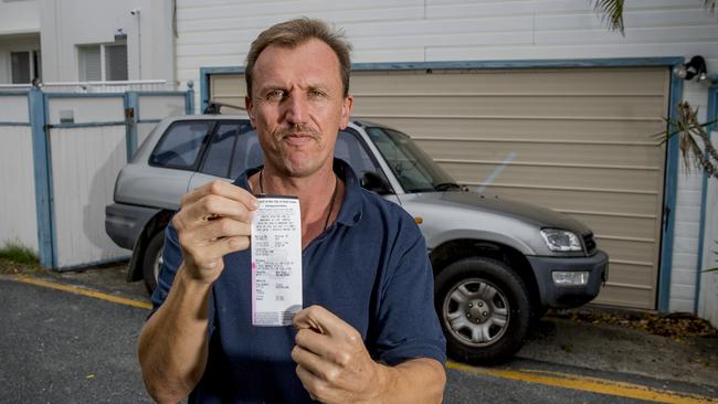 Johnathon Dao has lived in his Palm Beach home for the past five years and has always parked parallel in his small driveway. Yesterday he came out to find a $157 parking fine on his car, parking in his own driveway. Picture: Jerad Williams