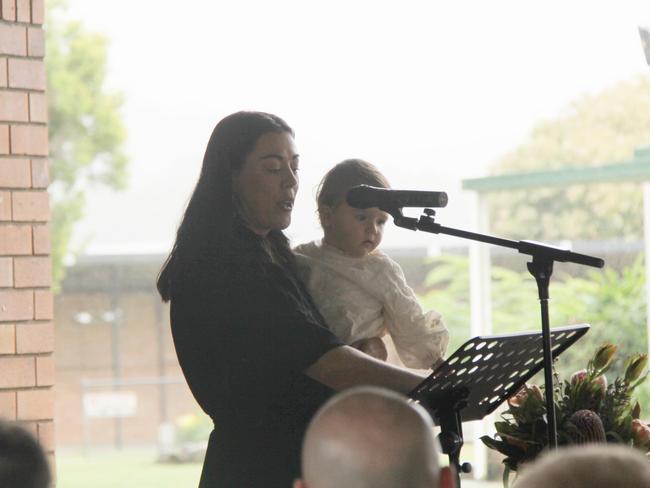 MY CAMERON: His partner Tara holds daughter Lennie as she speaks from the heart to more than 500 people about her love for Cameron Rodney Hyde, 32, who passed away from cancer. Photo: Alison Paterson