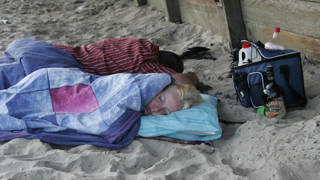 New Years eve party goers sleeping it off at Mooloolaba Beach on New Year’s Day in 2007. Picture: David Thomas