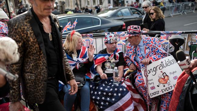 Royal fans wait along the proposed route of the carriage procession. Picture: AFP.