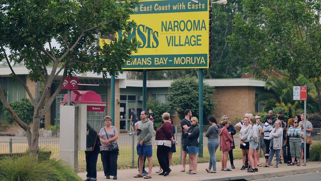 People queue at Narooma to phone their families to let them know they are safe. Picture: Gary Ramage