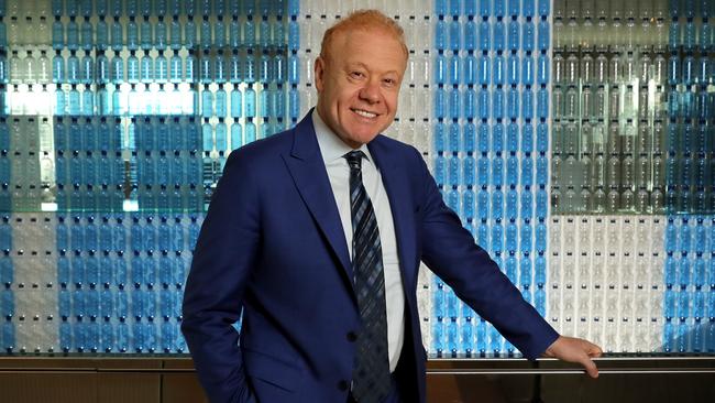 Anthony Pratt in front of a wall of plastic bottles at the Visy office in Melbourne. Picture: Stuart McEvoy/The Australian.