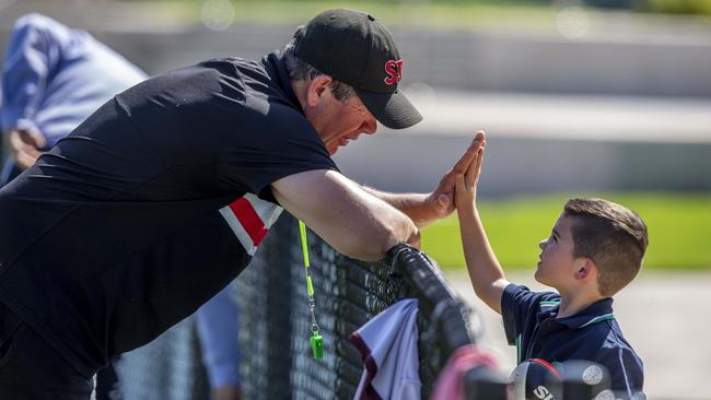 Brett Ratten gives a young Saints fan a high-five at training. Picture: Tim Carrafa