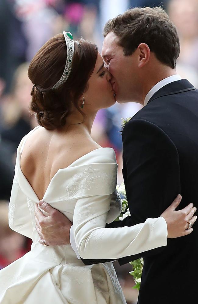 Britain's Princess Eugenie of York and her husband Jack Brooksbank kiss as they emerge from the West Door of St George's Chapel. Picture: AFP