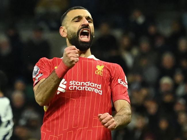 Liverpool's Egyptian striker #11 Mohamed Salah celebrates after scoring their fourth goal during the English Premier League football match between Tottenham Hotspur and Liverpool at the Tottenham Hotspur Stadium in London, on December 22, 2024. (Photo by Glyn KIRK / AFP) / RESTRICTED TO EDITORIAL USE. No use with unauthorized audio, video, data, fixture lists, club/league logos or 'live' services. Online in-match use limited to 120 images. An additional 40 images may be used in extra time. No video emulation. Social media in-match use limited to 120 images. An additional 40 images may be used in extra time. No use in betting publications, games or single club/league/player publications. /