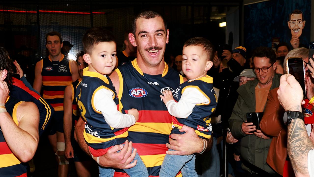 ADELAIDE, AUSTRALIA - JUNE 10: Taylor Walker of the Crows celebrates his 250th game with his sons Louis and Hugo during the 2023 AFL Round 13 match between the Adelaide Crows and the West Coast Eagles at Adelaide Oval on June 10, 2023 in Adelaide, Australia. (Photo by James Elsby/AFL Photos via Getty Images)