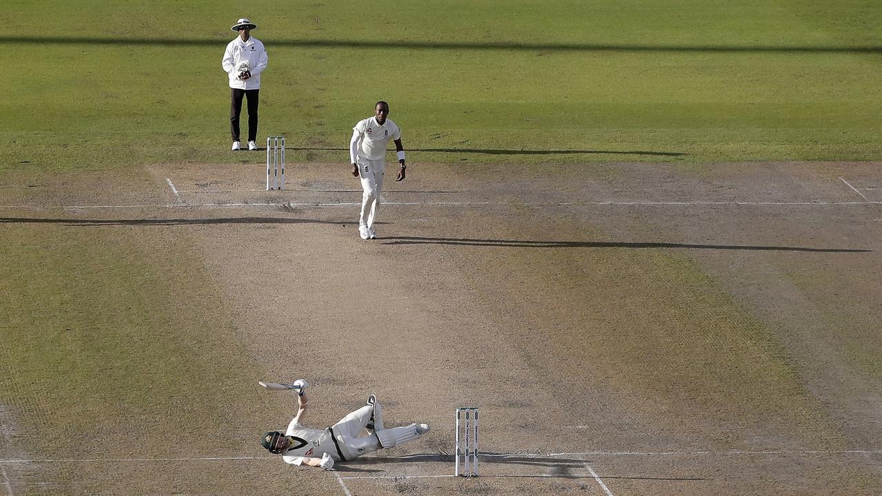 Steve Smith falls to the ground while attempting to play at a delivery from his nemesis Jofra Archer. Picture: Ryan Pierse/Getty Images.