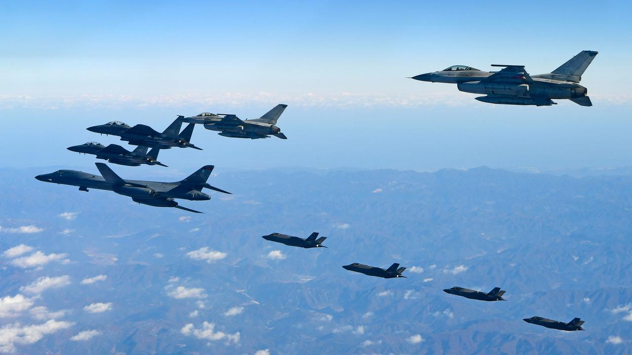 A US Air Force B-1B Lancer bomber (L), two US F-35A and two US F-35B stealth jets (far) flying over South Korea with South Korea fighter jets during a military drill. Picture: AFP