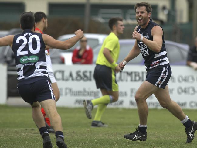 Southern Football League: Noarlunga v Flagstaff Hill. Noarlunga's Captain, Tom Caudle celebrates his snapped goal with team mate (20) Reece Martell. 13 April 2019. (AAP Image/Dean Martin)