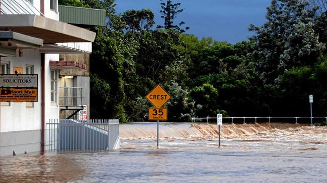 Water spilling over the levee wall at Molesworth Street. Picture: Cathy Adams