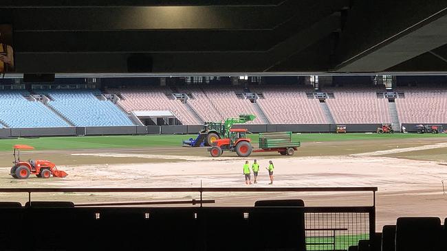 Tractors and workmen are busy ripping up and replacing the MCG turf. Picture: David Caird