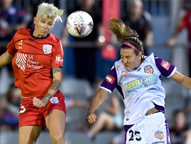 Michelle Heyman of Adelaide United (left) and Katie Naughton of Perth Glory compete for a header on Thursday night. Picture: AAP