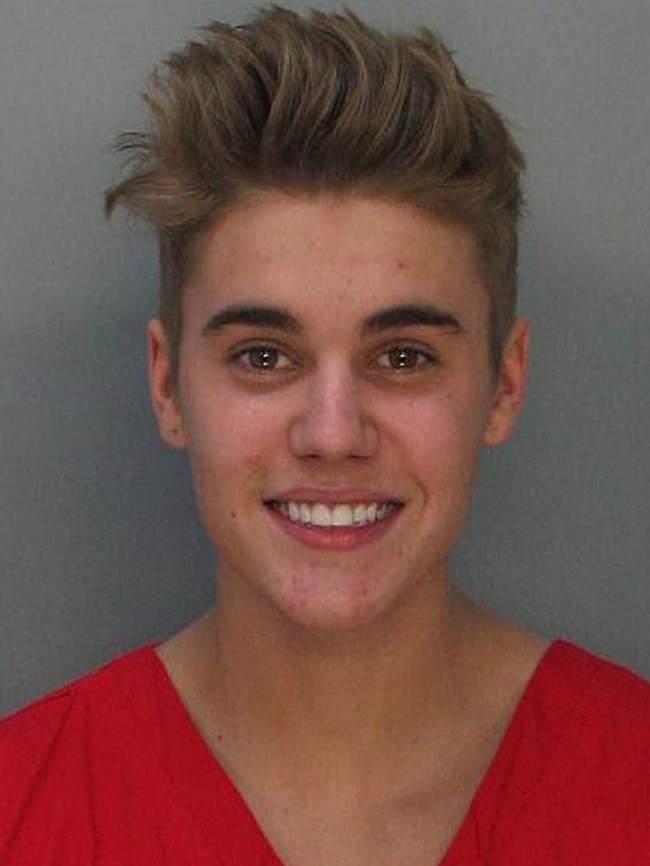 Justin Bieber poses for a booking photo at the Miami-Dade Police Department on January 23, 2014 in Miami, Florida. Justin Bieber was charged with drunken driving, resisting arrest and driving without a valid license after Miami Beach Police found the pop star street racing. (Photo by Miami-Dade Police Department via Getty Images)