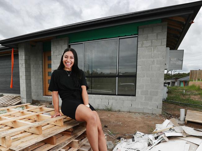 Young first home buyer Samantha Formby, 23, at the site where her new four-bedroom home is being built in Greenbank. Pics Tara Croser.