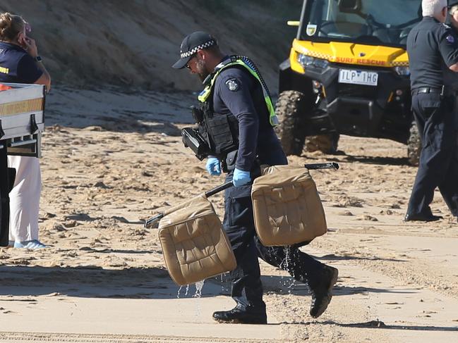 Police with seats from the crashed helicopter. Picture: Alan Barber
