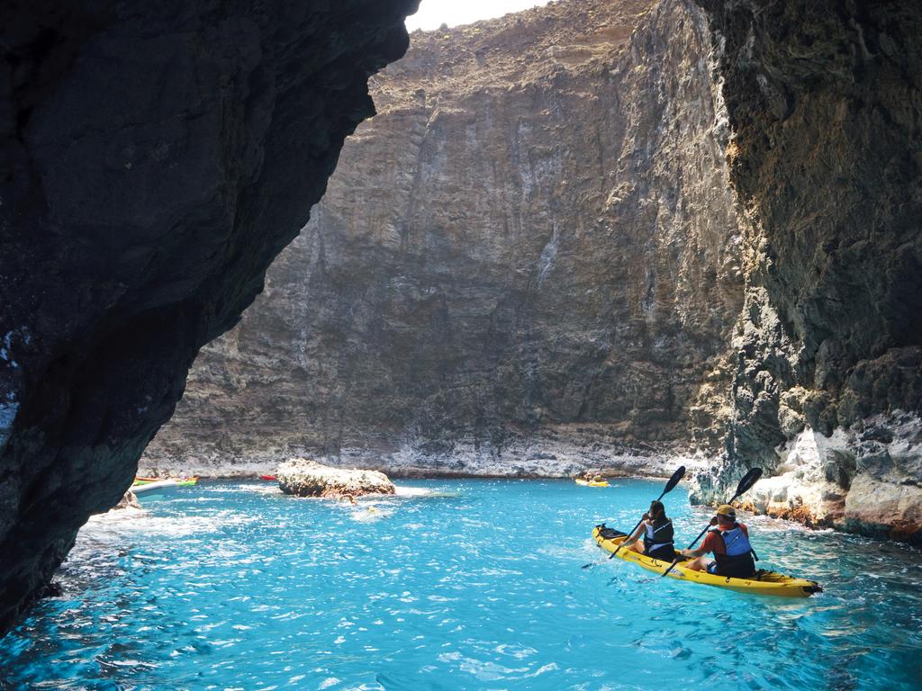 Hawaii’s waterfalls are a bucket list item, like this one on the Na Pali Coast on Kauai. Picture: Getty