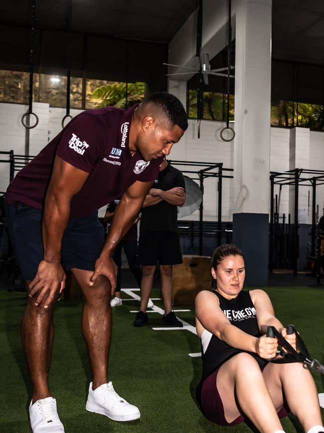 Sea Eagles Taniela Paseka gives some tips to Juliet Liddy during their training session at the Cube Gym. Picture: Monique Harmer.