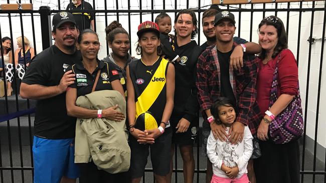 Richmond player Daniel Rioli with his father Bradley (left) and mother Belinda (second from the left).