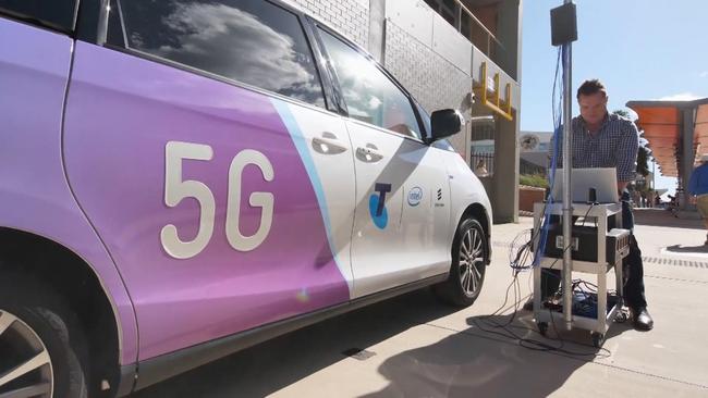 A Telstra technician works on installing 5G.