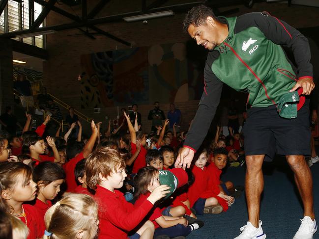 Rabbitohs player Dane Gagai hands out a Souths cap to a Darlington Public School student for answering correctly during a session to learn about caring for your teeth. Picture: John Appleyard