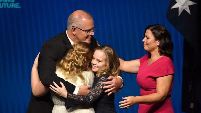 Australia's Prime Minister Scott Morrison (2nd L) hugs his daughters Abbey (L) and Lily (2nd R) with wife Jenny Morrison (R) after the Liberal Party's campaign launch in Melbourne on May 12, 2019. - Australia goes to the polls in a national election on May 18. (Photo by William WEST / AFP)