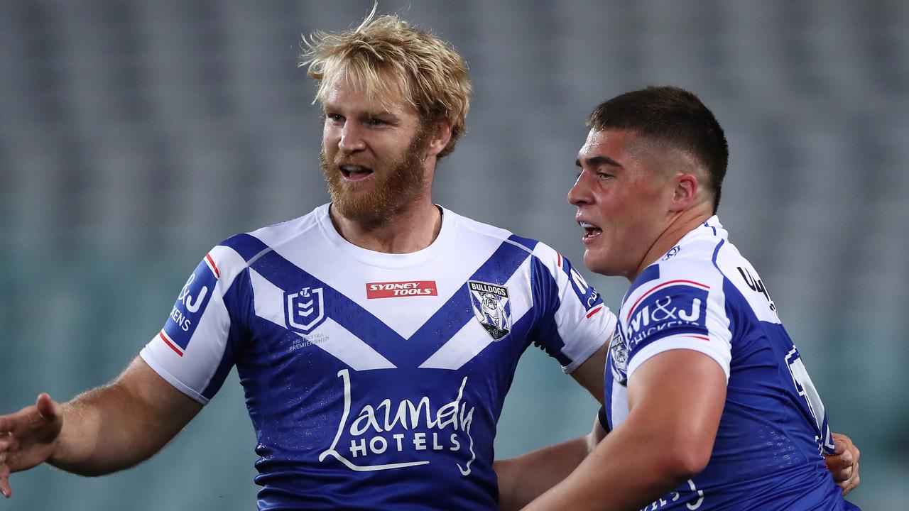 Matt Doorey celebrates with Aiden Tolman after scoring a try in his first season of NRL in 2020.