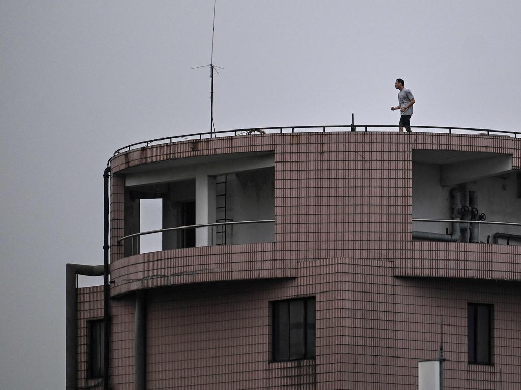 A man exercises on the rooftop of a residential building during a coronavirus lockdown in Shanghai. Picture: AFP