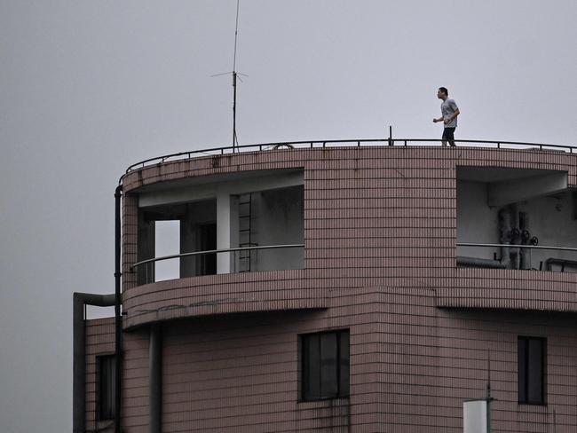 A man exercises on the rooftop of a residential building during a coronavirus lockdown in Shanghai. Picture: AFP