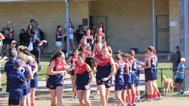 The Surfers Paradise Demons burst onto the field.