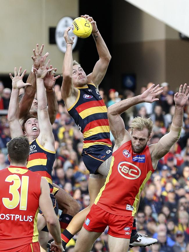 AFL - Adelaide Crows v Gold Coast Suns at Adelaide Oval. Hugh Greenwood marks over Jack Hombsch. Picture SARAH REED