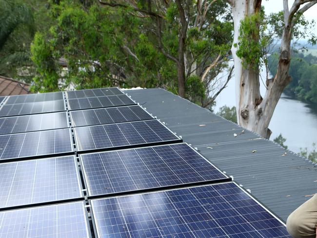 19/12/2018: Rod Grono is a small solar panel installer /repairer and electrician who estimates 50 per cent of his business is fixing badly-installed solar panels. He is the face, the man, the expert behind Western Sydney Solar. He's installing solar panels at a house in Freemans Reach on Wednesday afternoon. Hollie Adams/The Australian