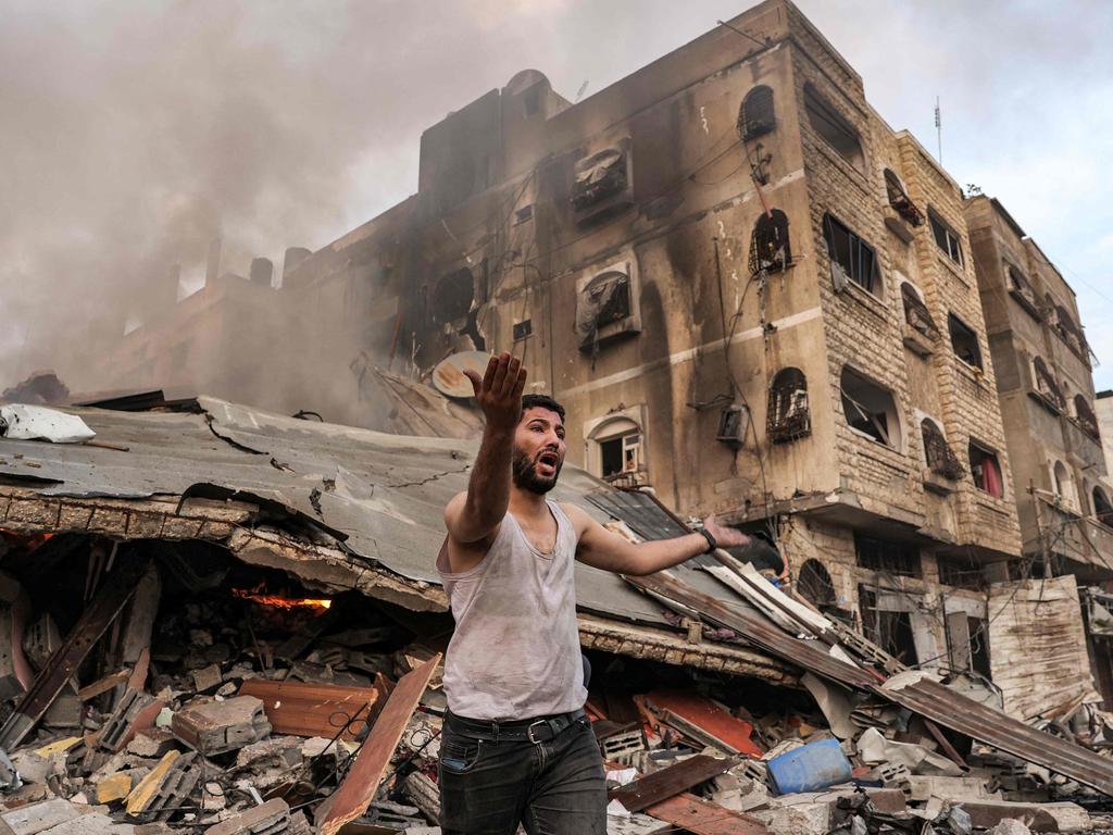 A man reacts outside a burning collapsed building following Israeli bombardment in Gaza City. Picture: AFP