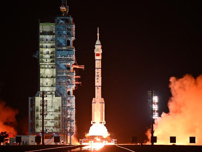 A long March-2F carrier rocket carrying the Shenzhou-19 spacecraft and crew of three astronauts lifts off from the Jiuquan Satellite Launch Center, in the Gobi desert, northwest China, on October 30, 2024. The mission of three astronauts to the Tiangong space station will carry out experiments with an eye to the space programme's ambitious goal of placing astronauts on the Moon by 2030 and eventually constructing a lunar base. (Photo by ADEK BERRY / AFP)