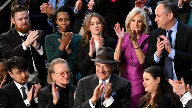 Jill Biden, US second gentleman Doug Emhoff, top right, Irish singer-songwriter Bono, former speaker Nancy Pelosi’s husband Paul, centre, and Brandon Tsay, bottom left, applaud Ukrainian envoy to the US Oksana Markarova. Picture: AFP