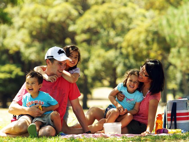 David Doran and his family, wife Huong and children Ashleigh, Bethany and Thomas enjoy a picnic in Centennial Park.