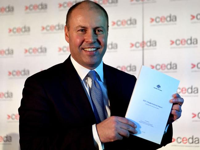 Australian treasurer Josh Frydenberg holds a copy of the 2021 Intergenerational Report in Melbourne on June 28, 2021. (Photo by William WEST / AFP)