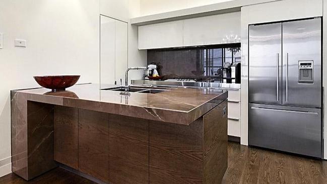 The deluxe kitchen has marble benchtops and Miele appliances.