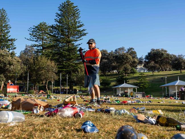 Council workers cleaning up the mess. Picture: Tom Parrish