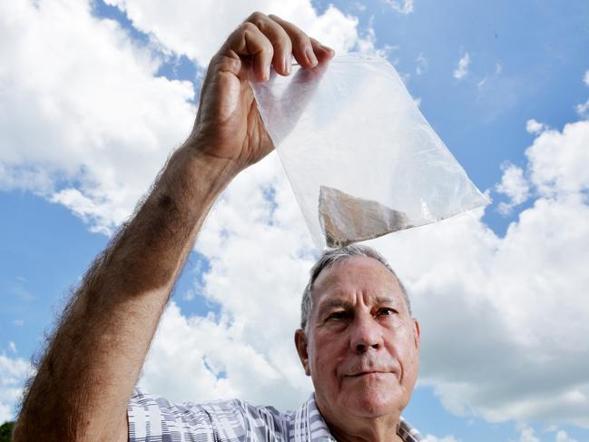 Dr Bill Day with a sample of asbestos he says he found at Kulaluk, next to the Minmarama Aboriginal community. Pictures: Patrina Malone/Elise Derwin