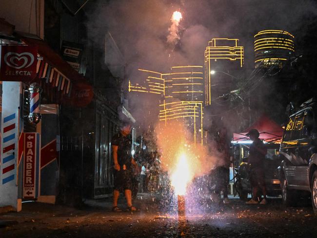 People let off fireworks in the street as they celebrate New Year in Mandaluyong City, Metro Manila on December 31, 2024. Picture: AFP